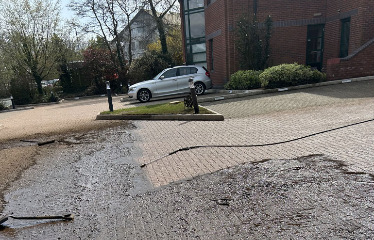 Commercial pressure washing cleaning a paved driveway and exterior surface in Liverpool